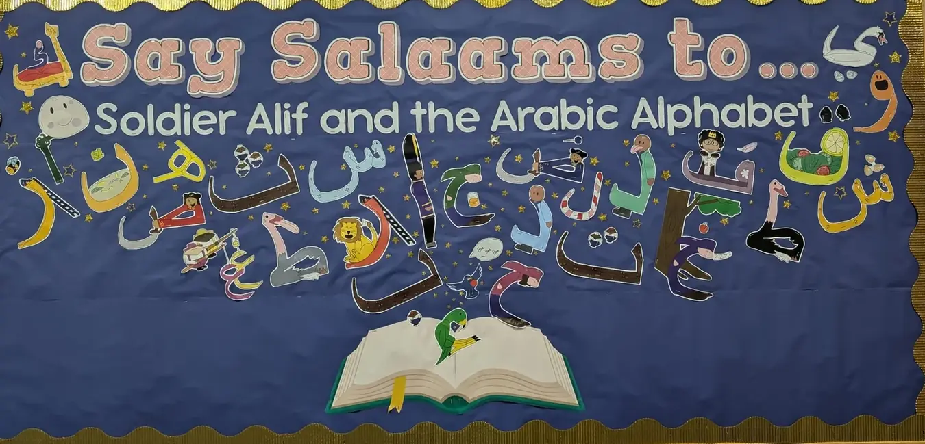 A school display board titled Say Salaams to Soldier Alif and the Arabic Alphabet, covered in hand-drawn Arabic letter characters.